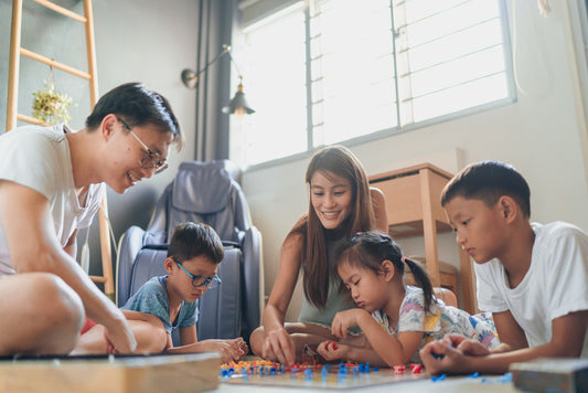 Family playing a board game in their home's playroom