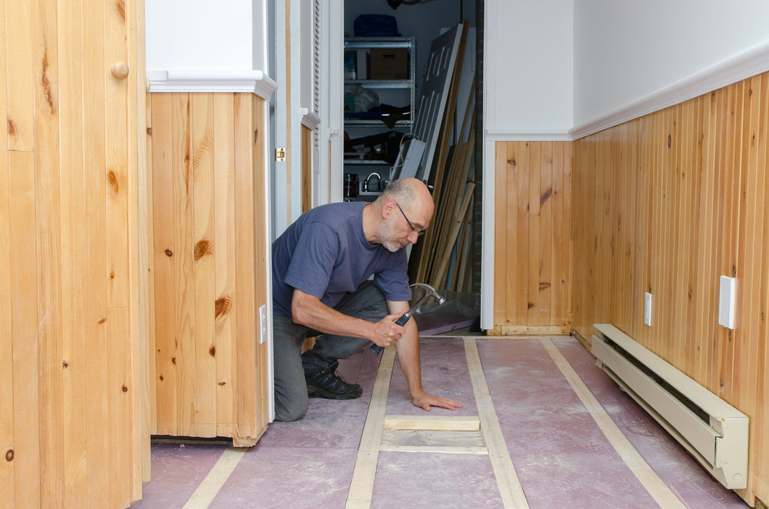 Man finishing a basement floor in his home