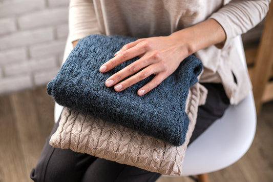 woman unpacking and storing fall sweaters for the cold season