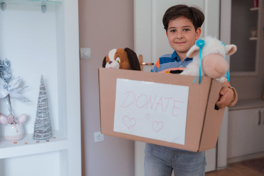 boy clearing away toys to donate during the holidays