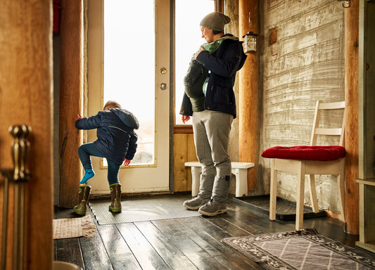 family putting on winter gear to go outside