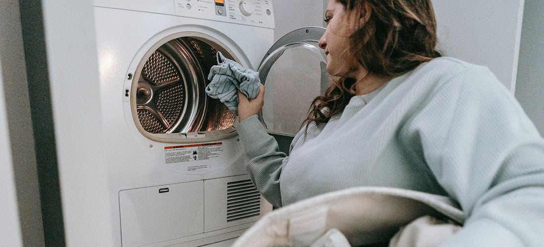 couple folding laundry in their renovated laundry room