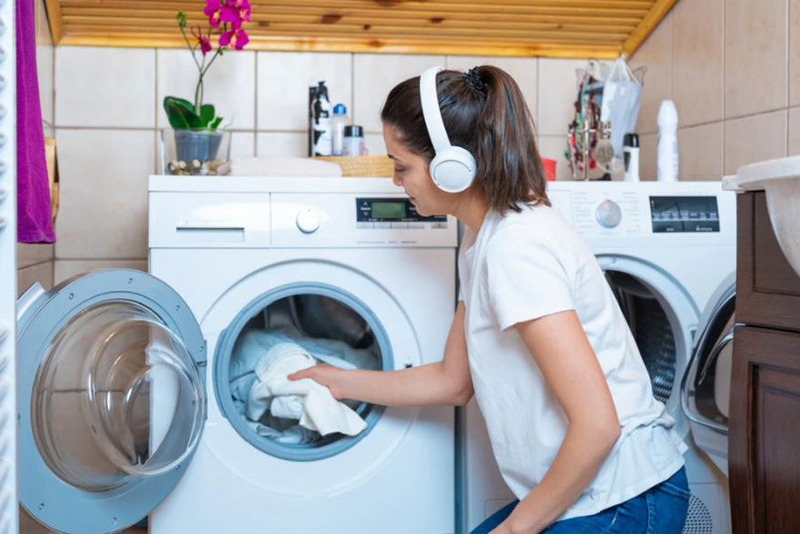 Homeowner doing laundry in a decorated laundry room