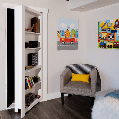 Murphy Door® Contractor Grade Bookcase Hidden Door, a white DIY bookcase door, partially open, concealing a dark room, in a modern kid's space.