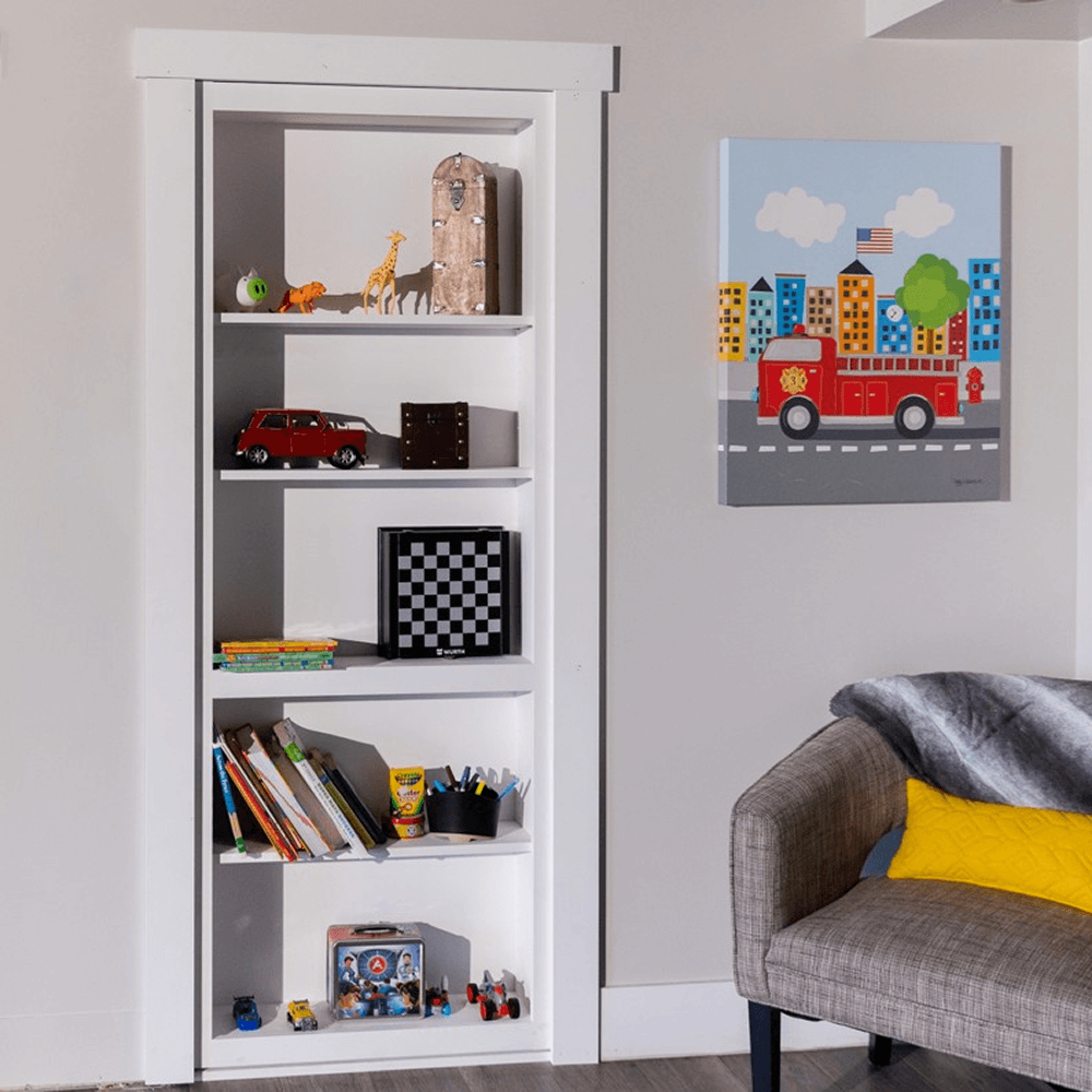 Murphy Door® white Contractor Grade Bookcase Hidden Door. Flush-mount DIY Bookcase Door with toys & books, blending seamlessly.