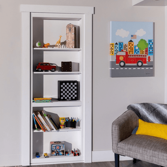 Murphy Door® white Contractor Grade Bookcase Hidden Door. Flush-mount DIY Bookcase Door with toys & books, blending seamlessly.