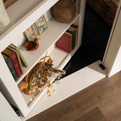 Murphy Door® DIY Quick Kit - Primed Only: a white flush mount bookcase door, partially open, revealing a hidden room.