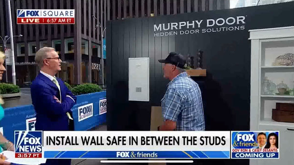 FOX News segment showcasing Murphy Door® hidden door solutions with wall safe installation demonstration between two presenters outdoors.