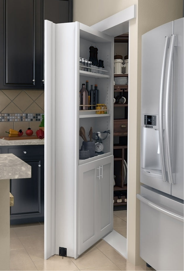 Murphy Door® white pantry hidden door with shelving for kitchen storage, beside stainless refrigerator in modern kitchen.
