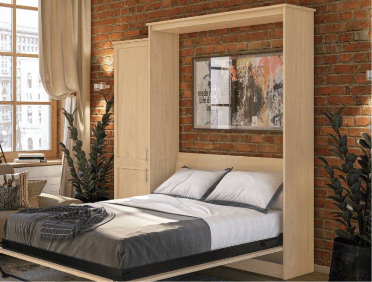 Murphy Door® wall bed with light wood finish, folded down in modern bedroom with exposed brick wall and urban artwork.