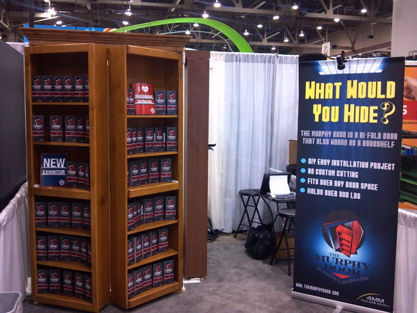 Murphy Door's first trade show booth with bookshelf doors and What Would You Hide banner