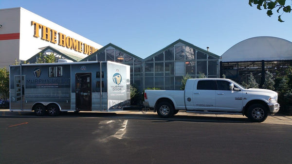 Murphy Door mobile showroom trailer parked at a Home Depot store