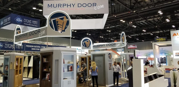 Murphy Door trade show booth with illuminated overhead signage