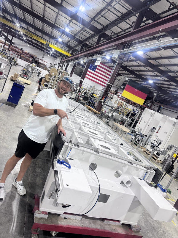 Jeremy Barker with new automated manufacturing equipment at the Homag factory