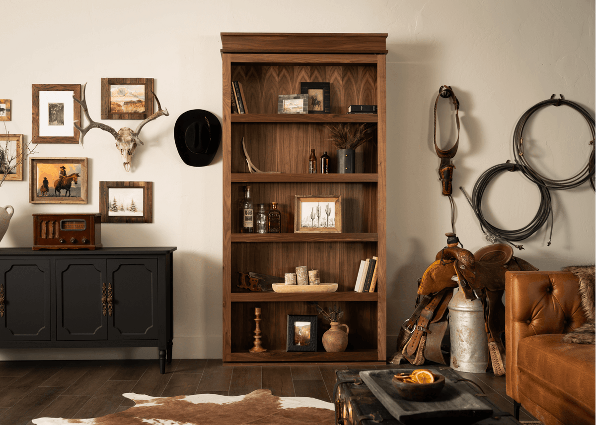 Murphy Door® dark brown hidden door bookcase with patterned wood interior, adorned with western decor.