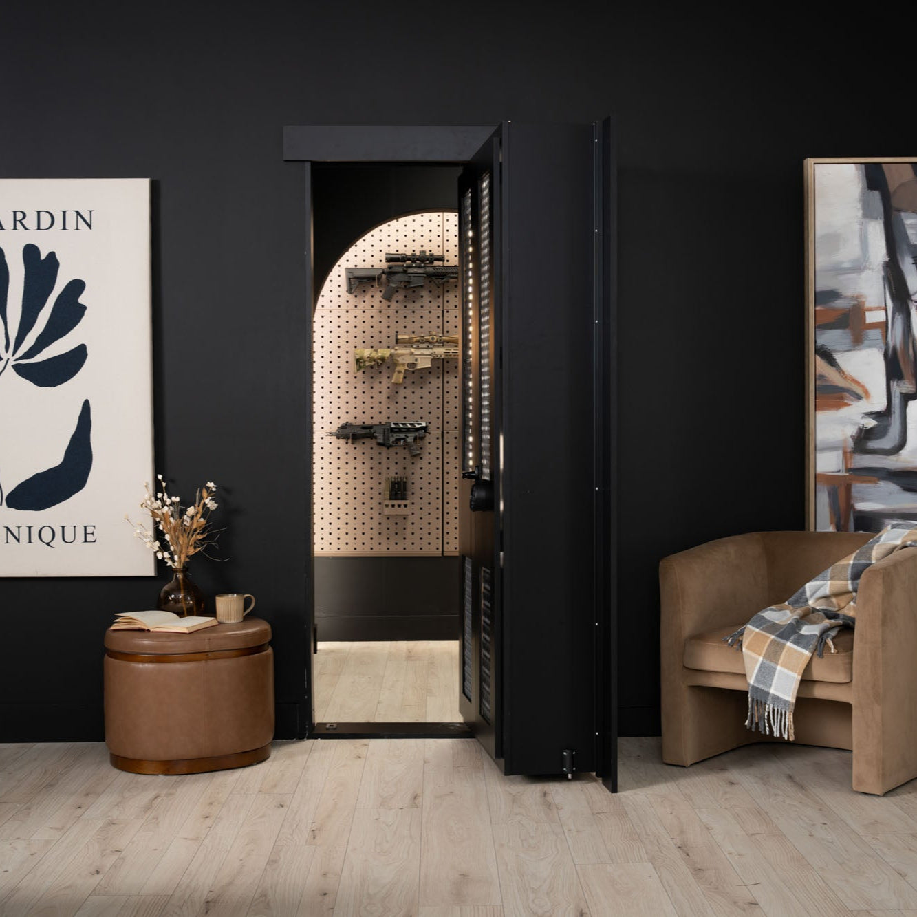 Murphy Door® hidden gun cabinet with matte black exterior opening to reveal arched pegboard storage for firearms, set in stylish dark room.