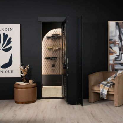 Murphy Door® hidden gun cabinet with matte black exterior opening to reveal arched pegboard storage for firearms, set in stylish dark room.