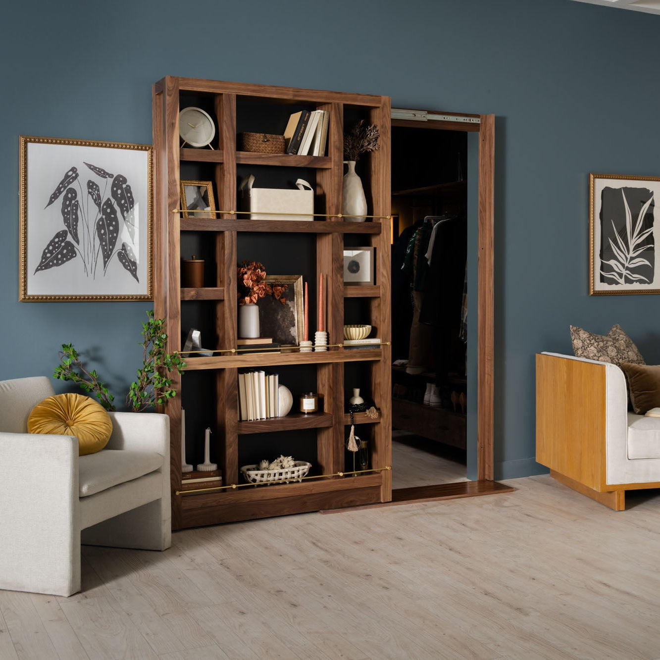 Murphy Door® wooden room divider with sliding bookcase shelving in dark walnut, displaying decor against teal walls.